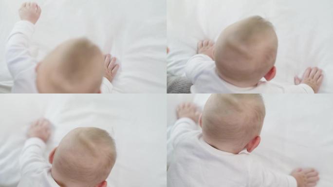 一个婴儿在家里的床上爬行的4k视频片段