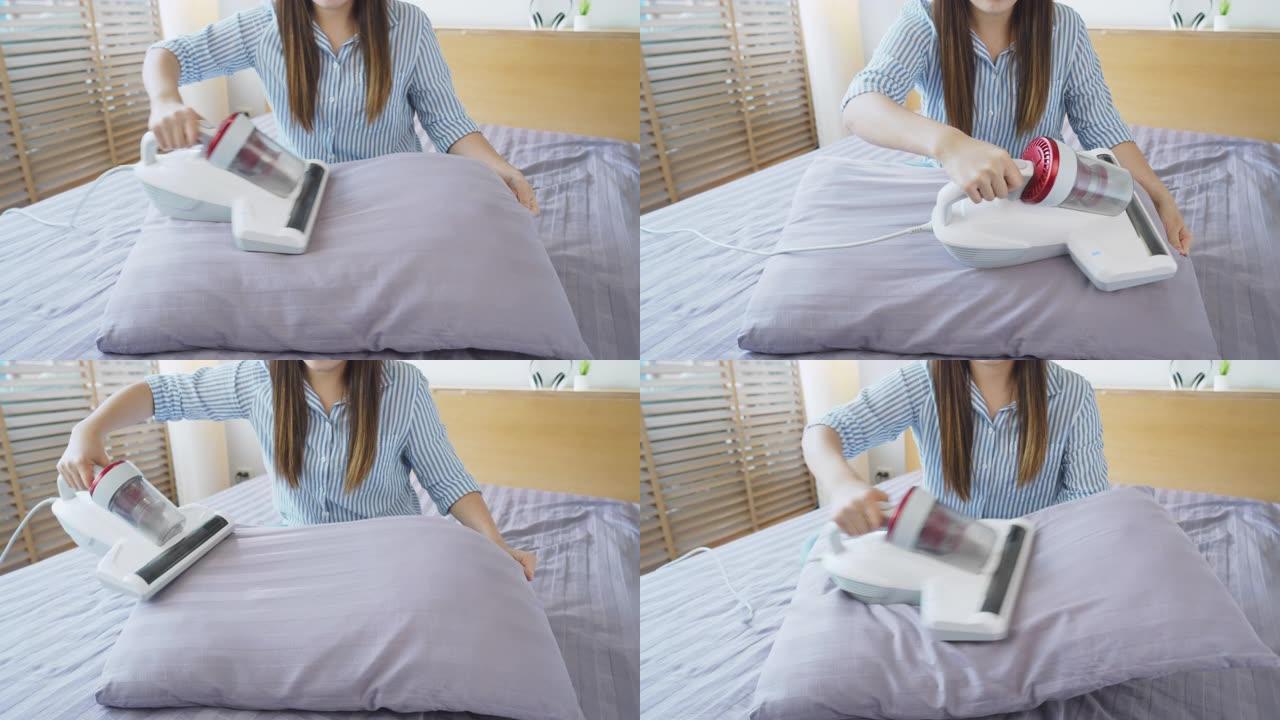 卧室枕头上使用吸尘器的女人