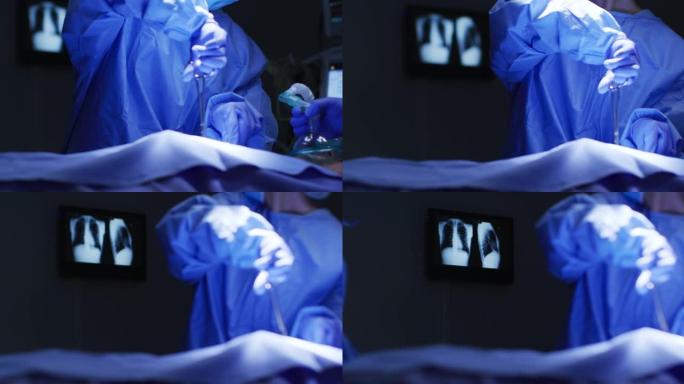 外科医生在手术室穿着防护服手持剪刀的中段
