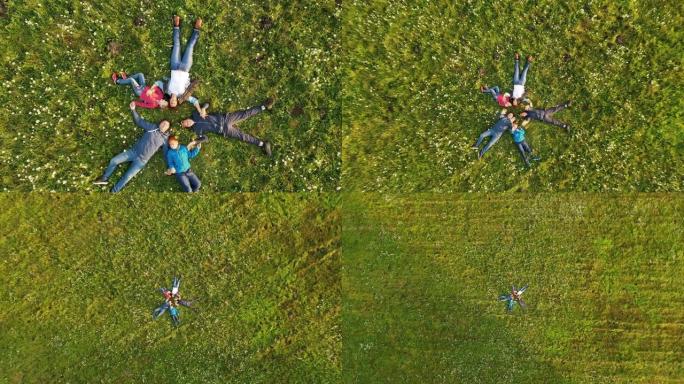 空中家庭在草地上围成一圈时向摄像机挥手