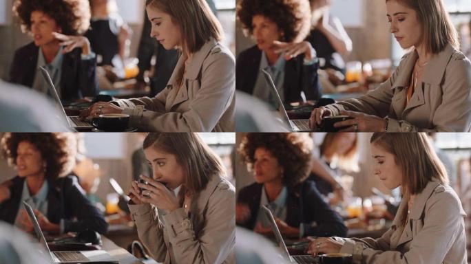 年轻女子使用笔记本电脑在咖啡馆工作，在智能手机社交媒体上输入电子邮件共享消息，享受坐在繁忙的餐厅喝咖