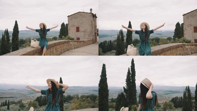 SLO MO年轻女子在Pienza的城墙上欣赏美景