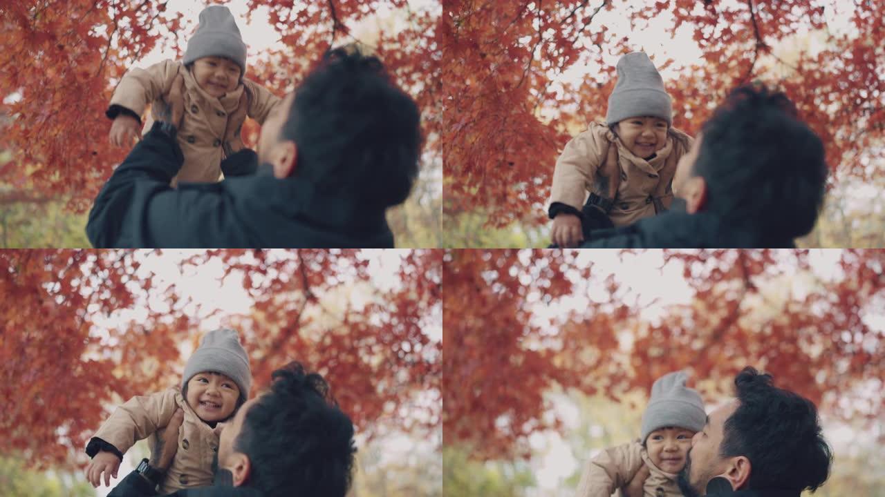 小女孩和父亲在秋天的城市公园玩耍和度假。