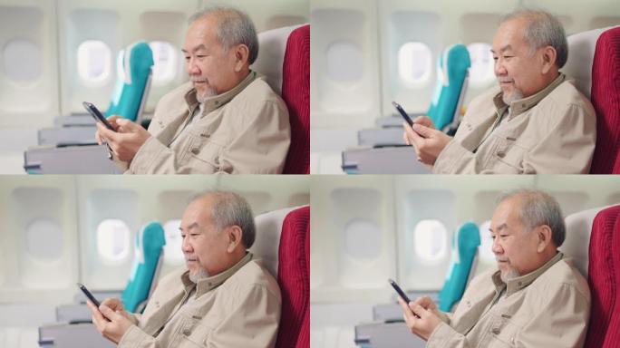 成熟的旅游男子在等待起飞期间使用智能手机。