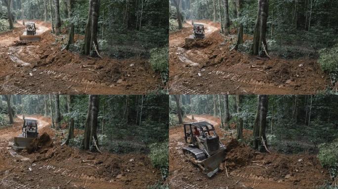 空中。推土机将道路变成热带雨林，便于接触原木树。气候变化。森林砍伐