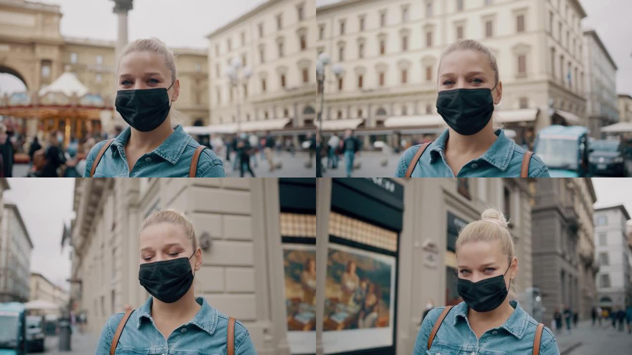 在佛罗伦萨的购物区，戴着面具的SLO MO女游客看着相机