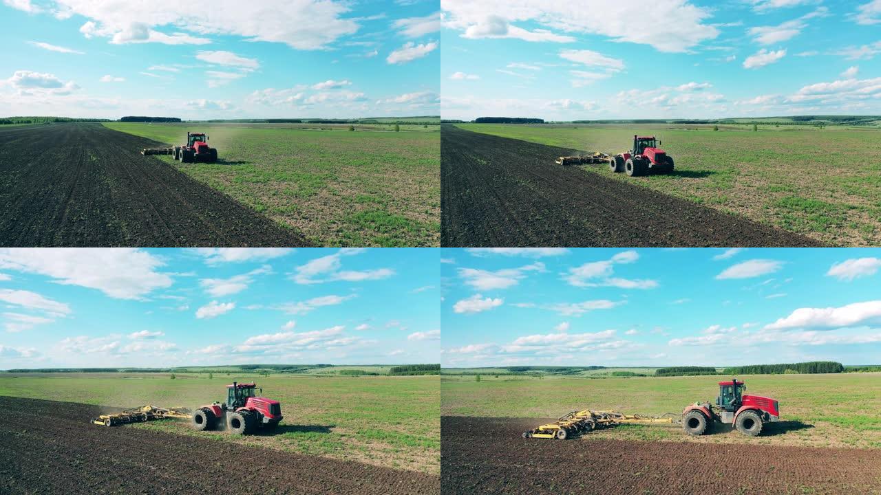 农用拖拉机在田地上耕作。