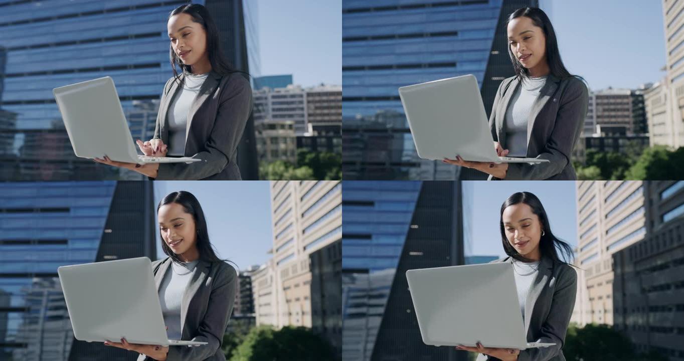 4k视频片段，一位迷人的年轻女商人在办公室阳台上户外使用笔记本电脑