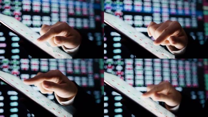 数字平板电脑上的特写手势，用于分析股市