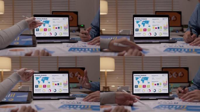 近距离会议小组亚洲人晚上在小办公室举行的手工会议