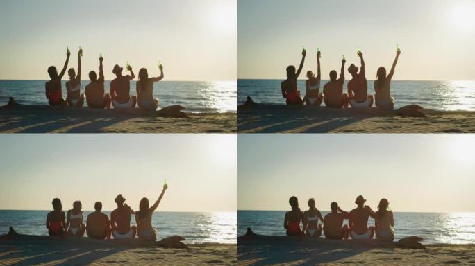 穿着泳衣的年轻多民族朋友的慢动作正在为他们的暑假一起在日落时分大海的海滩上欢呼啤酒。