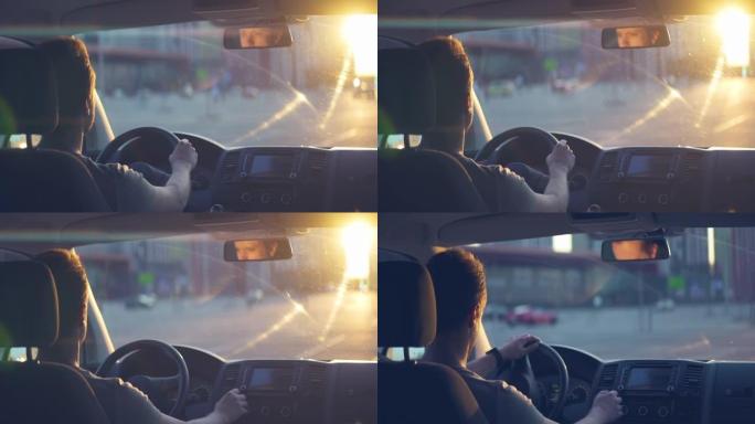 日落背景下的人开车。变形镜头拍摄