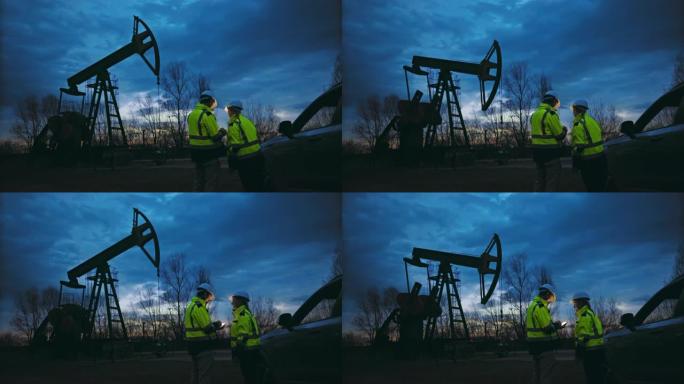 SLO MO石油工人一边观察抽油机的运行，一边用智能手机分析数据