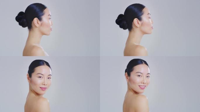 亚洲女人的慢动作轮廓视图，美丽的脸庞和完美的皮肤刚刚从杂质中清洗干净，准备白天或晚霜在镜头前微笑。