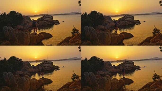 意大利撒丁岛日落时在岩石上行走的人的景色。