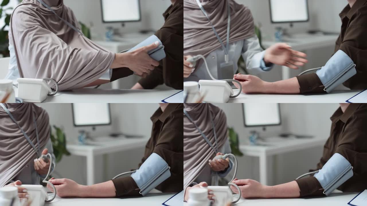 穆斯林女性全科医生测量患者的血压