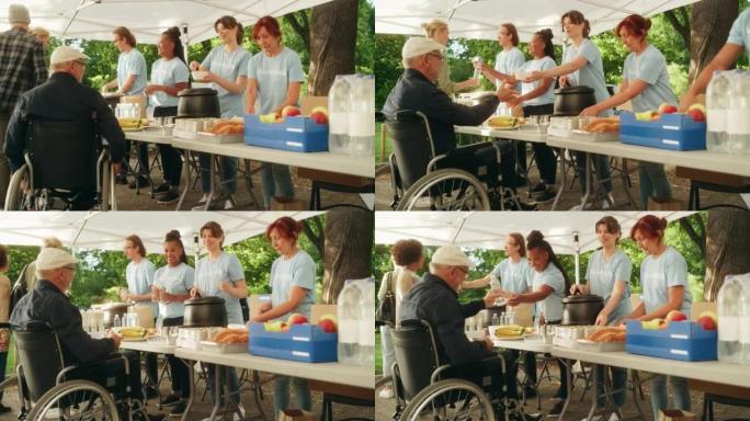 志愿者团队在当地社区食品银行提供帮助，在阳光明媚的日子里向公园的低收入人群分发免费食物。使用轮椅的残