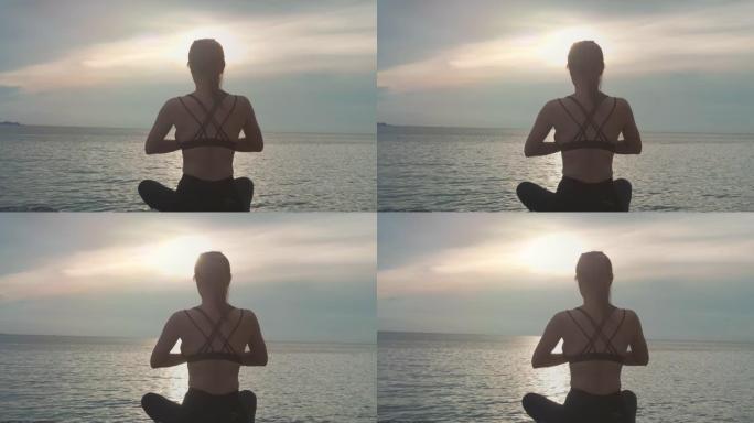 女人坐着瑜伽放松沙滩海边瑜伽女人海边度假