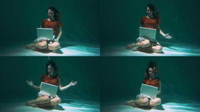 迷人的年轻快乐的老板商务女性使用笔记本电脑在线潜水水下慢动作。工作狂概念