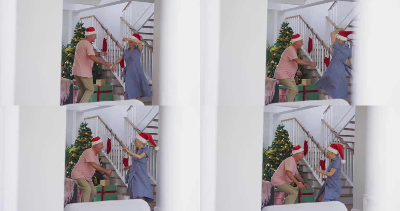 快乐的高加索高级夫妇戴着圣诞老人的帽子并在圣诞节跳舞的动画