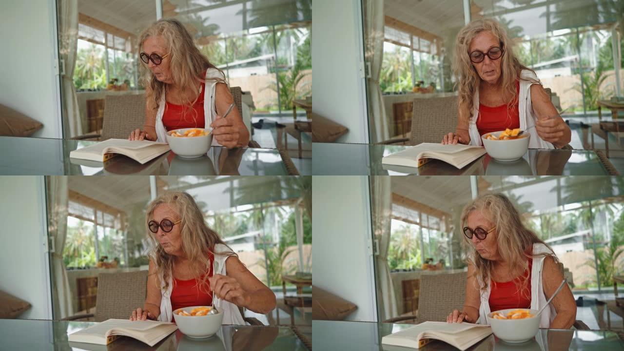 吃早餐的高级女性中近景看书吃饭的外国老人