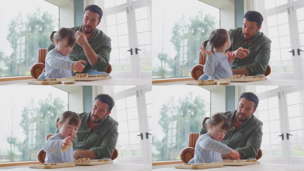 父亲与唐氏综合症女儿一起在家玩木制游戏