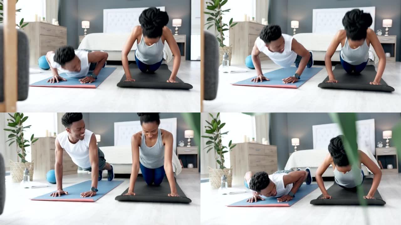 年轻夫妇在家里一起做有氧运动。黑人和黑人妇女在他们的卧室里使用瑜伽垫，锻炼和做俯卧撑。健身、锻炼和训