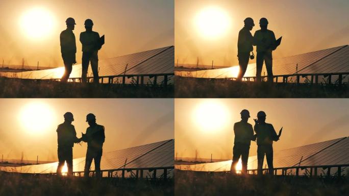 两名太阳能专家在日落时用万用表读数