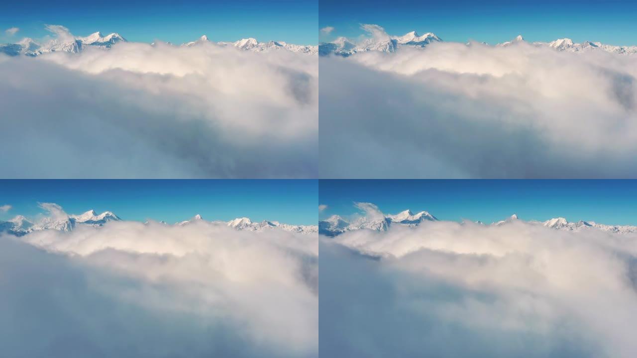 云瀑倾泻在雪山前云海