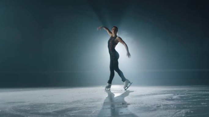 年轻的女性艺术花样滑冰运动员的电影镜头正在比赛开始前在溜冰场上表演女子的单人滑舞蹈。完美、精确、自由