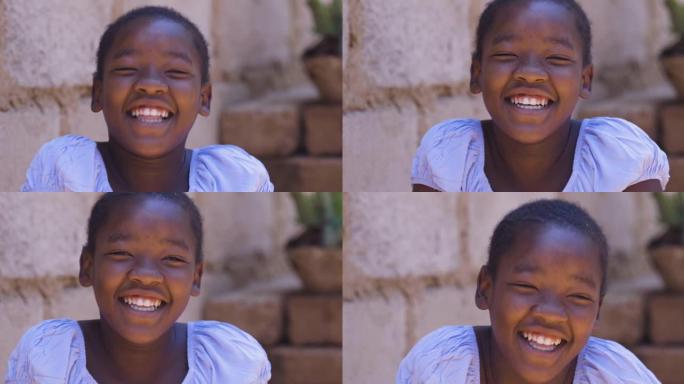 贫穷。不平等。肖像。可爱的年轻黑人非洲女孩笑着看着相机
