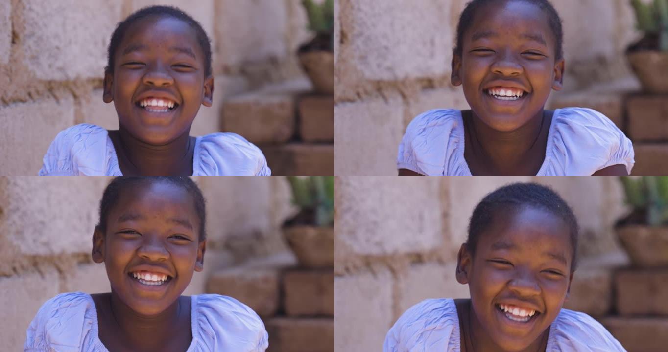 贫穷。不平等。肖像。可爱的年轻黑人非洲女孩笑着看着相机