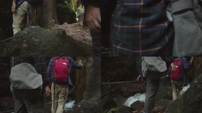 亚洲徒步旅行者爬上森林中的瀑布。