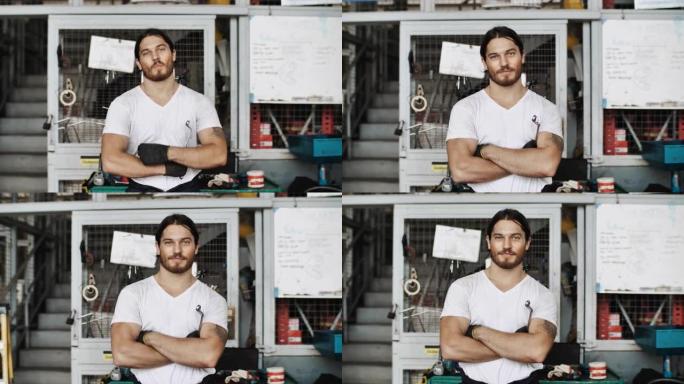 亚洲年轻技工站在维修店双臂交叉的肖像