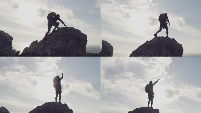 一个年轻人在山顶庆祝徒步旅行完成的4k视频片段