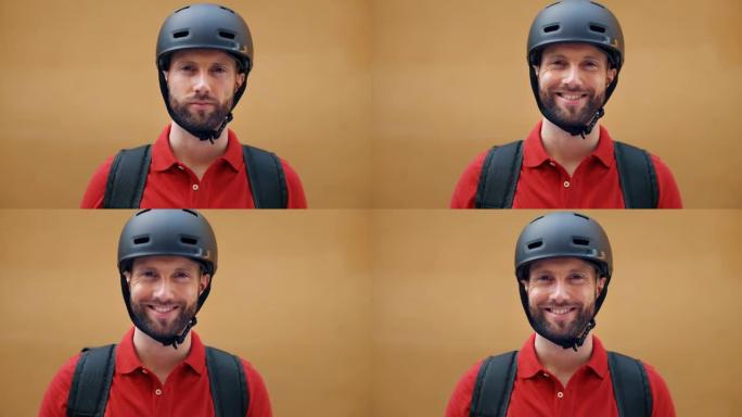 一名戴着安全头盔的年轻男性快递员的特写镜头在用自行车将订单交付给客户之前，在镜头前微笑着。