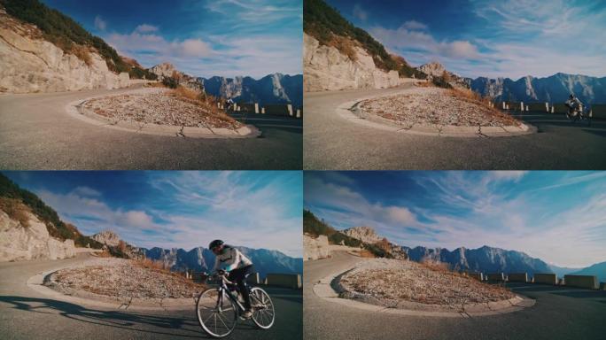 骑自行车的人在风景秀丽的山中骑自行车上坡