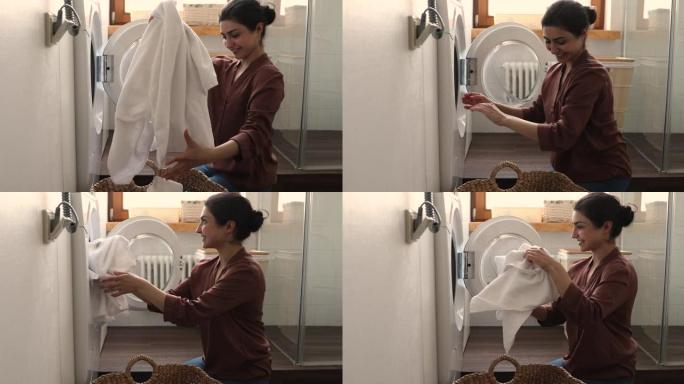 印度家庭主妇做家务把浴巾放进洗衣机
