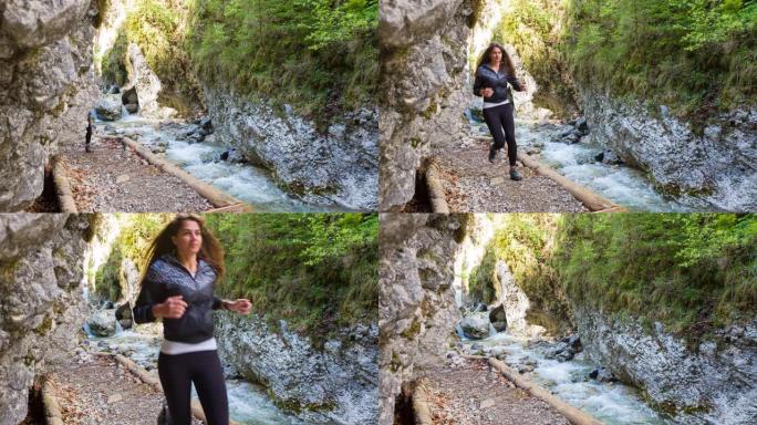 健康的女人在山溪谷慢跑