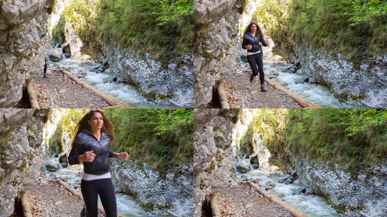 健康的女人在山溪谷慢跑