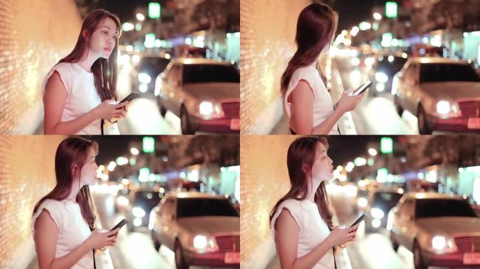 SLO MO年轻亚洲女子用手机叫计程车