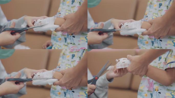护士的手特写，儿童患者的手LV滴去除。