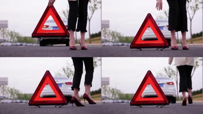 妇女放置红色警告三角形