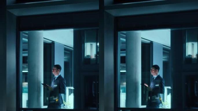 外面的镜头: 在办公室里用数字平板电脑工作的商人。经理站在窗边检查电子邮件。垂直屏幕方向9:16的视