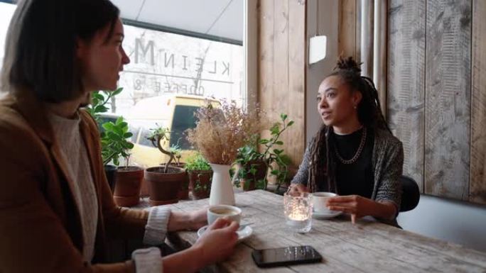 两个女商人在咖啡馆喝咖啡时聊天