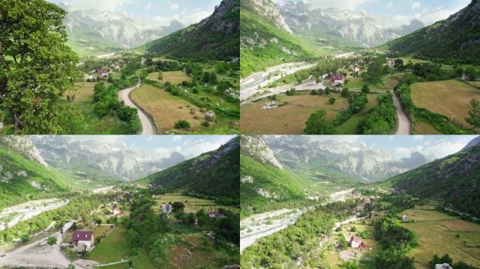 在阿尔巴尼亚thi山谷的古老木制教堂和树木附近飞行。阿尔巴尼亚阿尔卑斯山国家公园的鸟瞰图。背景上的村