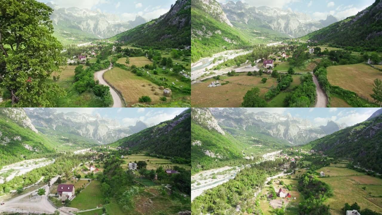 在阿尔巴尼亚thi山谷的古老木制教堂和树木附近飞行。阿尔巴尼亚阿尔卑斯山国家公园的鸟瞰图。背景上的村