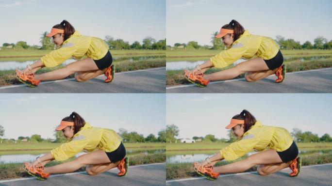 女运动员在慢跑前伸展身体。