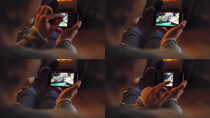 一名男子花时间浏览智能手机上的照片的4k视频片段