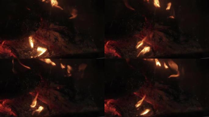 冬天，从厚厚的玻璃防火门可以看到燃木火炉内的火焰。特写。4k分辨率。